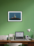lighthouse framed print in room with green wall