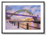 Framed photograph of a bridge over a river with a snowy landscape.