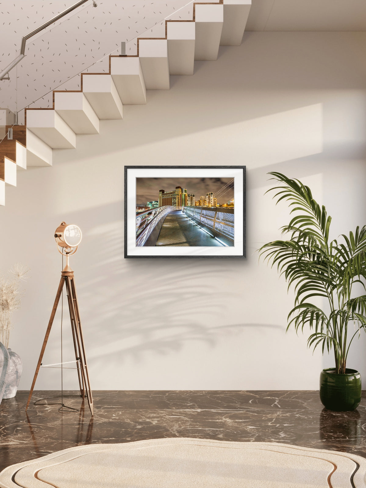 Framed artwork on a wall with a plant and floor lamp in a modern interior setting