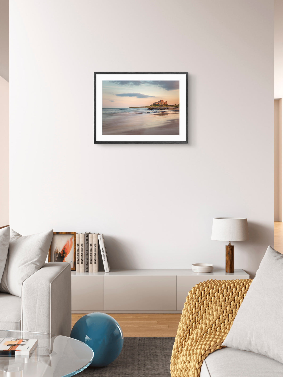 Bamburgh Castle reflected on the beach wall art displayed in a styled room setting.