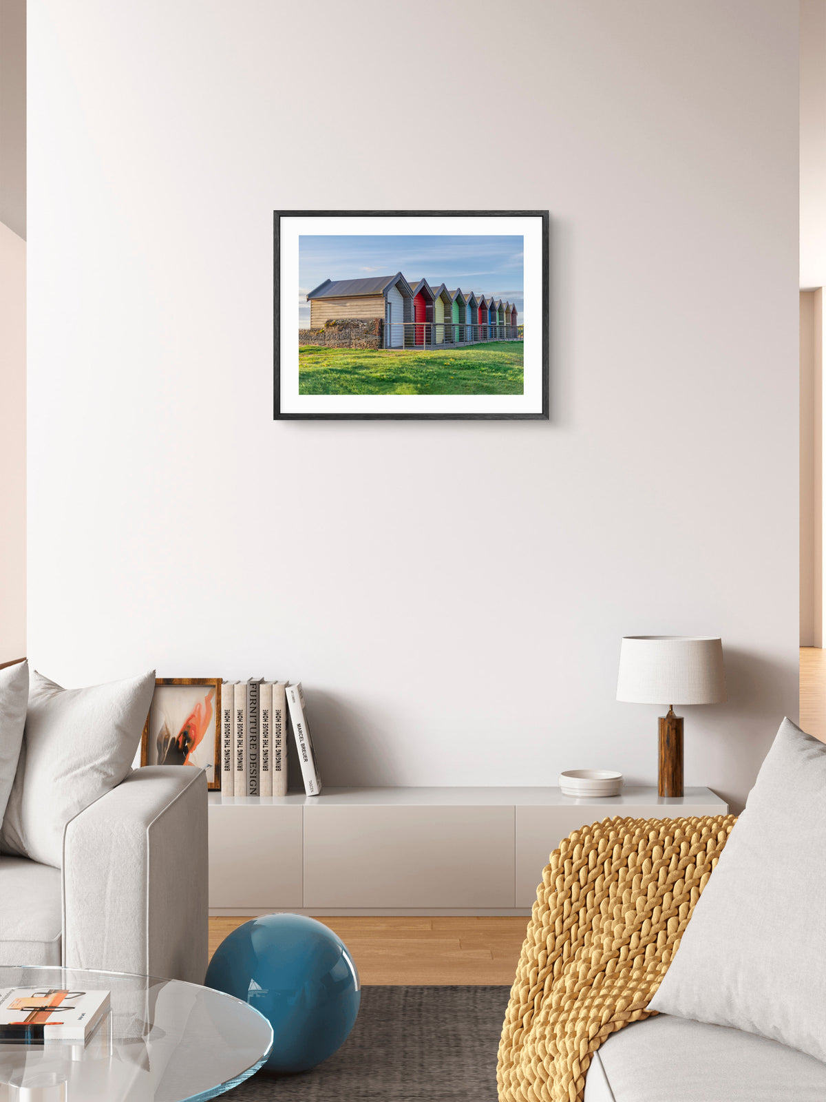 Colourful beach huts at Blyth wall art displayed in a styled room setting.