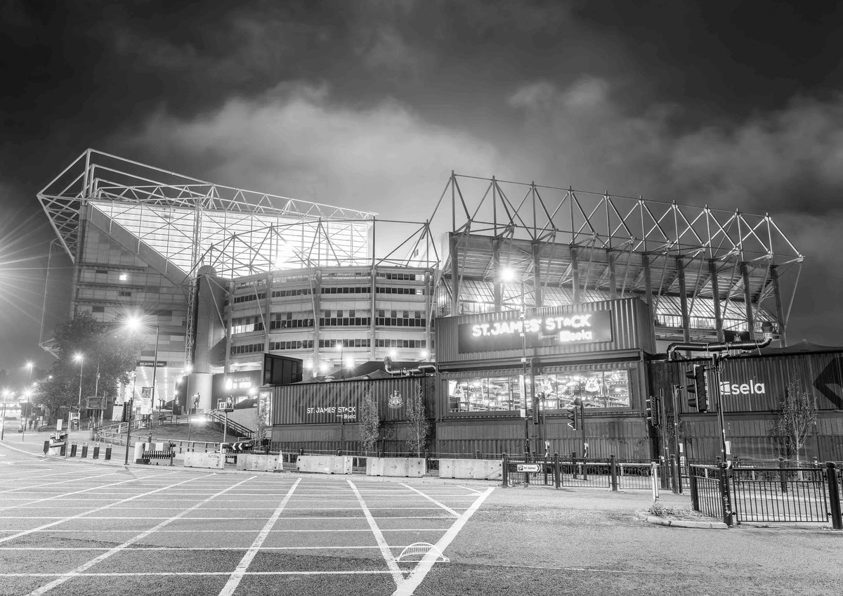Stadium at night with illuminated signage
