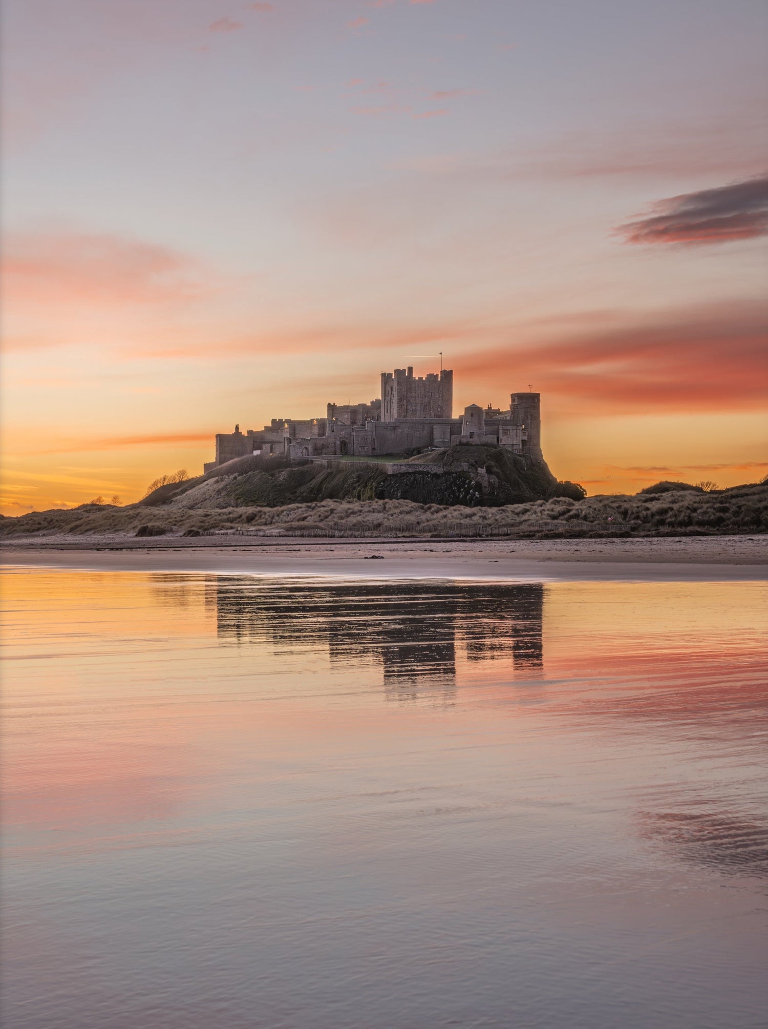 Castle on a beach at sunset with a framed border
