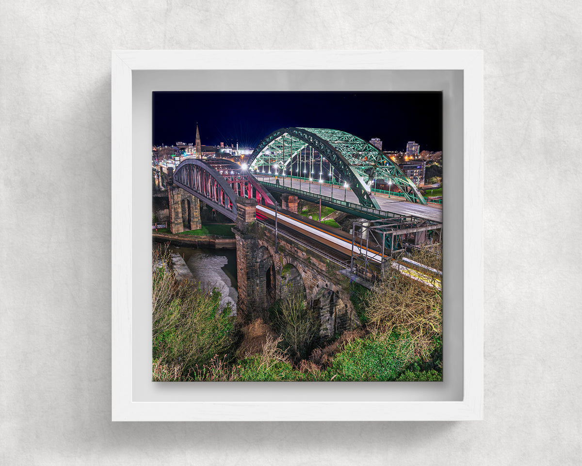 Wearmouth Bridge at Night on an 8×8 inch ceramic tile in a white box frame, front view