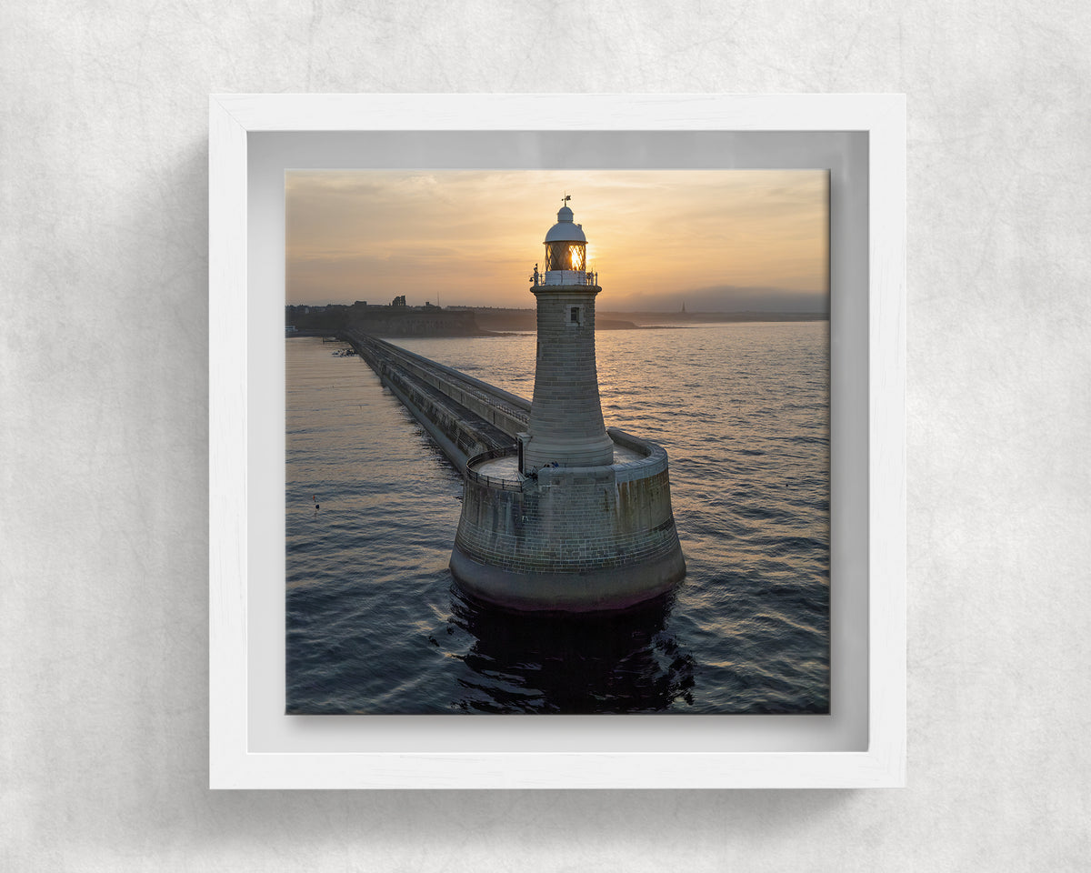 Tynemouth Pier Lighthouse at Sunrise on an 8×8 inch ceramic tile in a white box frame, front view