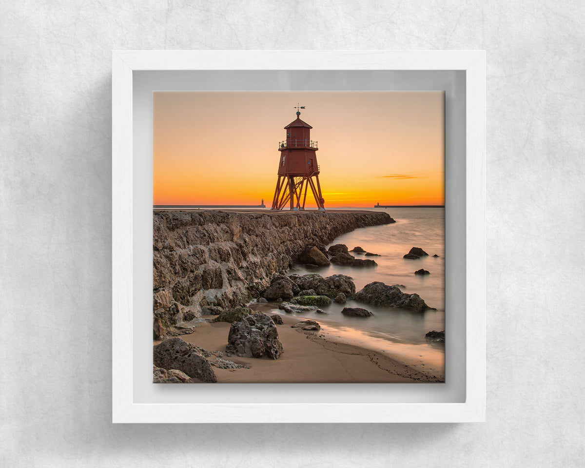 Herd Groyne Lighthouse at Sunrise on an 8×8 inch ceramic tile in a white box frame, front view