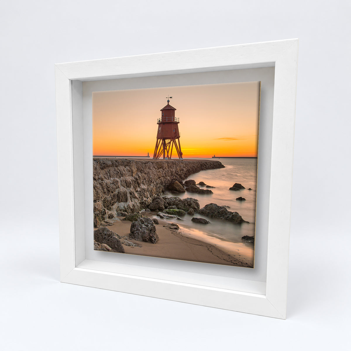Herd Groyne Lighthouse at Sunrise on an 8×8 inch ceramic tile in a white box frame, angled view