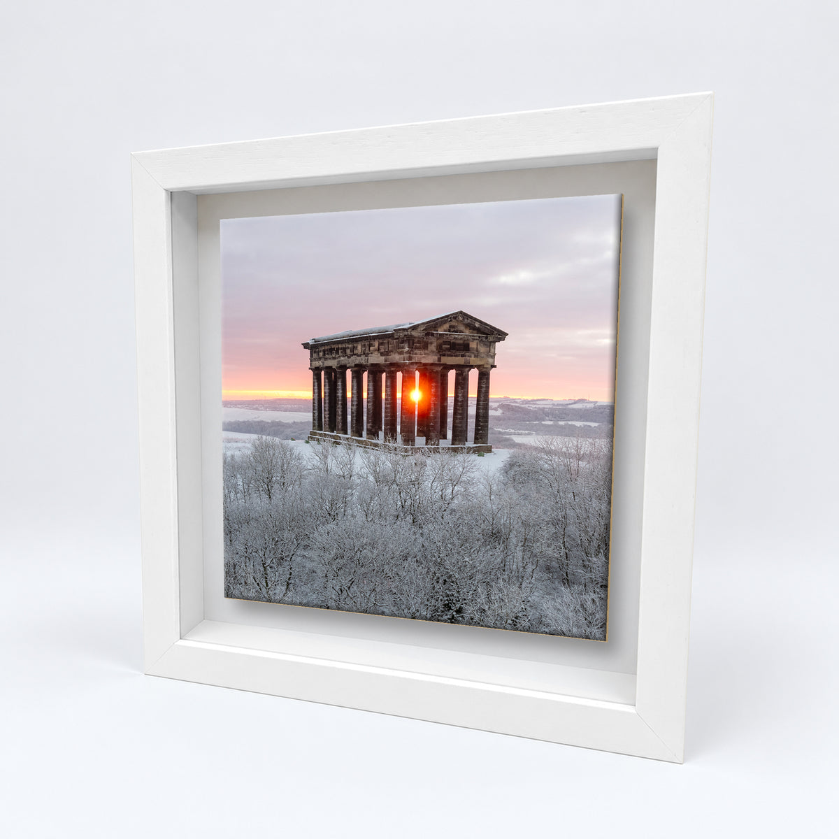 Penshaw Monument in Snow on an 8×8 inch ceramic tile in a white box frame, angled view