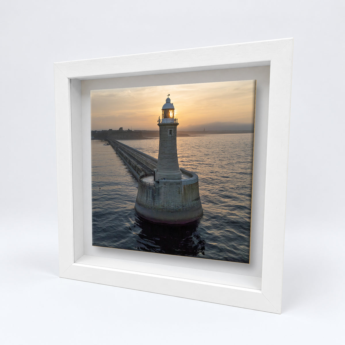 Tynemouth Pier Lighthouse at Sunrise on an 8×8 inch ceramic tile in a white box frame, angled view