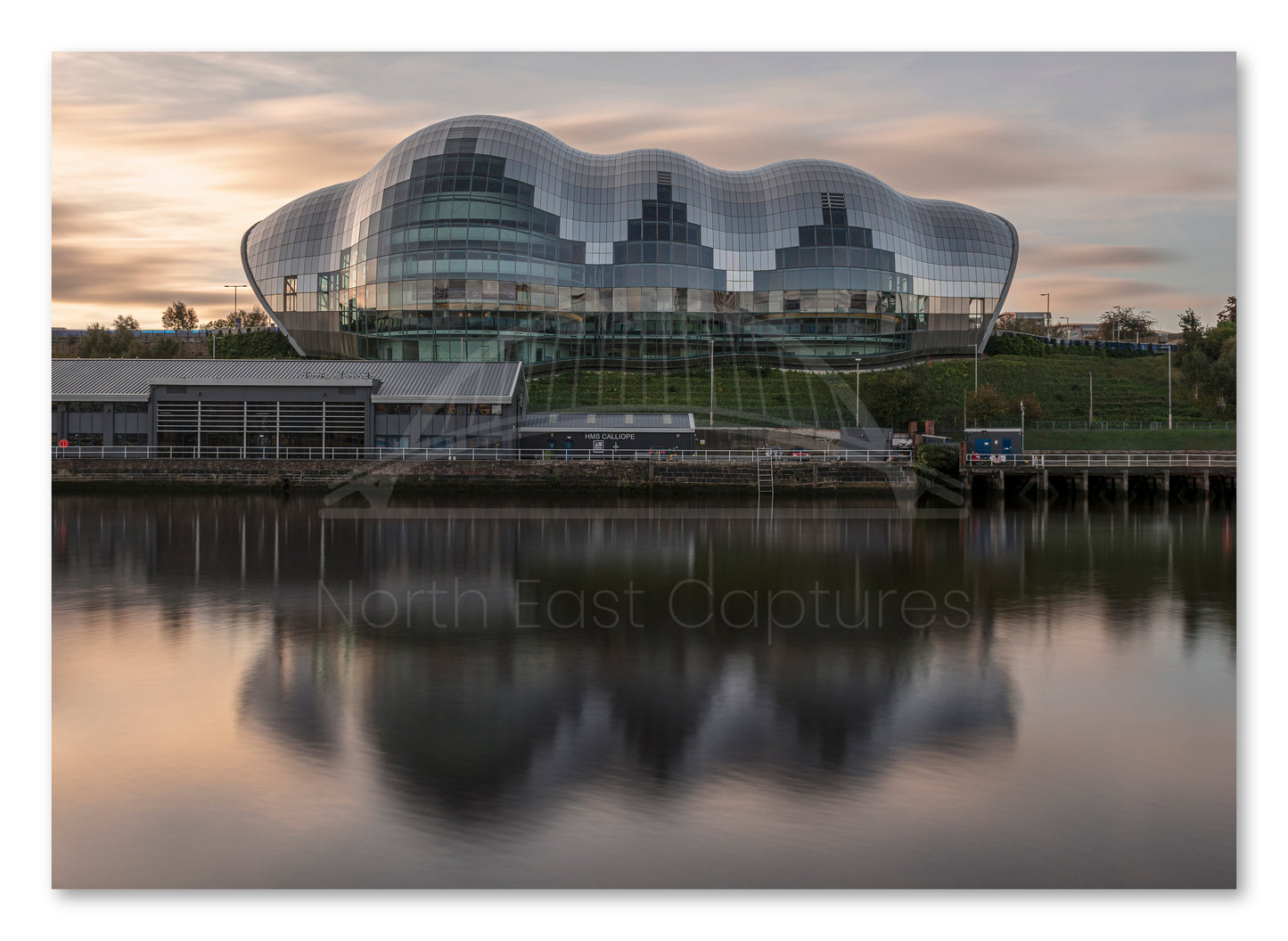 The Glasshouse (Sage) Gateshead - Reflecting on The River Tyne at Sunrise - Gateshead shown as a canvas print.