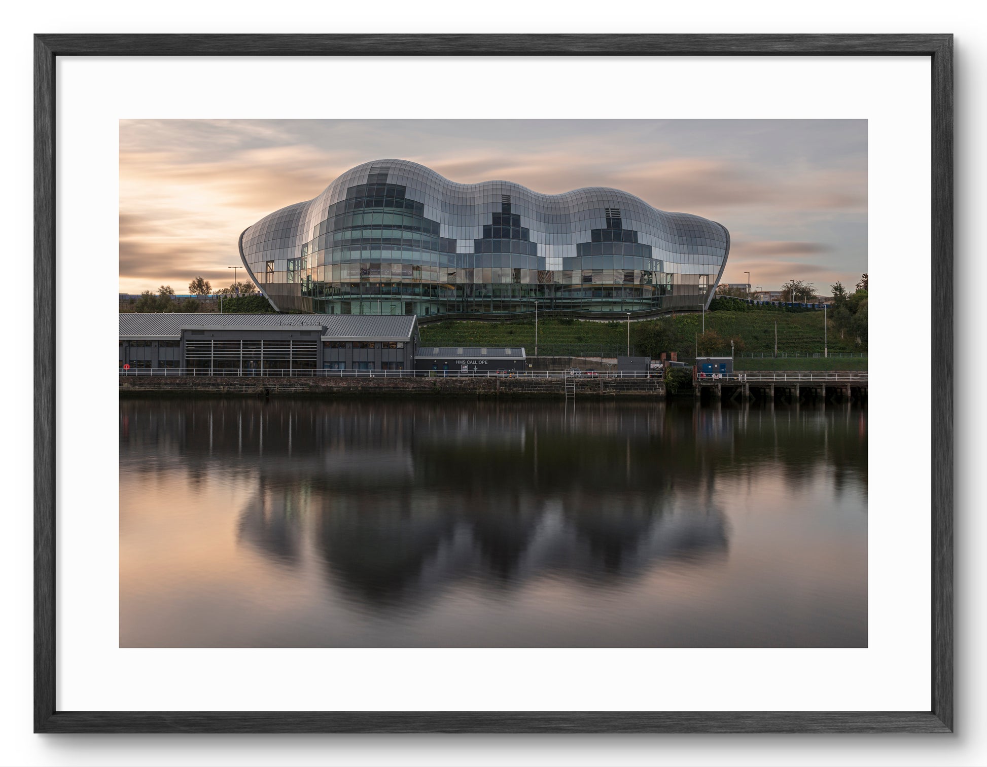 The Glasshouse (Sage) Gateshead - Reflecting on The River Tyne at Sunrise - Gateshead shown as a framed photographic print.