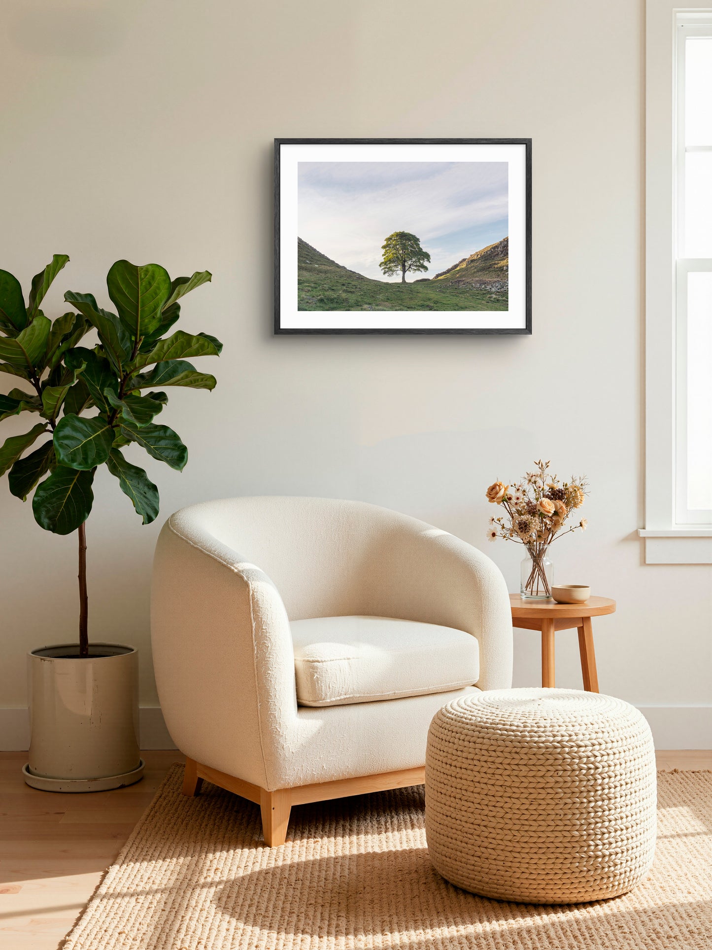 Sycamore Gap Tree wall art displayed beside a cream chair and plant in a room setting.