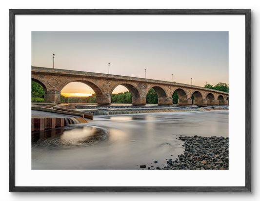Hexham Bridge - Crossing The Tyne - Sunset through Arches - Hexham shown as a framed photographic print.