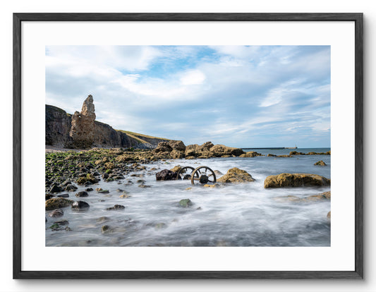 Chaldron wagon wheels on Chemical Beach at Seaham shown as a framed photographic print.