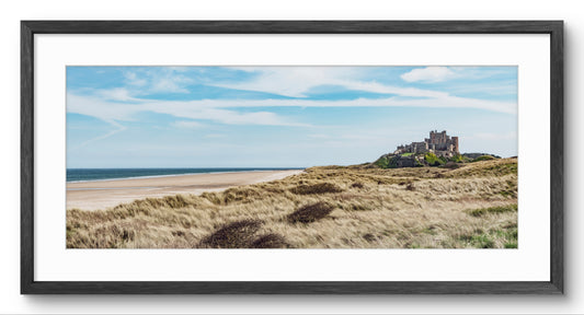 Bamburgh Castle & Sand Dunes panoramic print — black frame and white mount