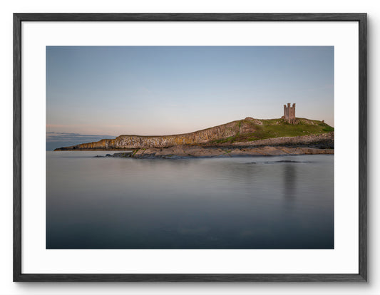 Lilburn Tower - Dunstanburgh Castle - Northumberland shown as a framed photographic print.