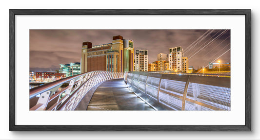 Baltic & Millennium Bridge at Night panoramic print — black frame and white mount