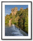 Framed photograph of a cathedral with a river and trees in the foreground