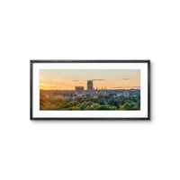 Framed photograph of a cityscape with a sunset over a cathedral.