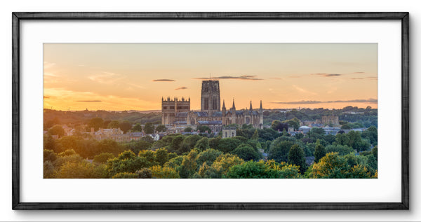 Framed photograph of a cathedral at sunset with trees in the foreground