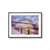 Framed photograph of a bridge over a river with a snowy landscape.