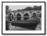 Boat docked at a stone bridge over water