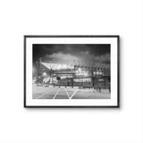 Framed black and white photo of a sports stadium at night.
