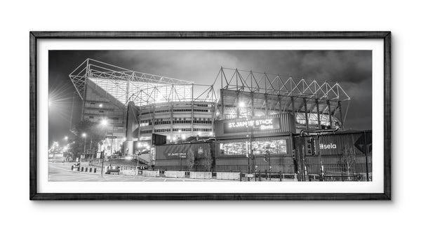 Framed black and white photo of a stadium at night
