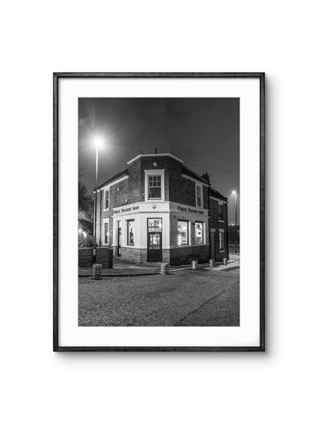 Black and white framed photograph of a building at night.