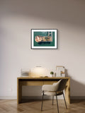 Framed artwork above a desk in a home office setting