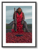 Statue of a soldier covered in red poppies with a rifle, set against a cloudy sky.