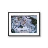 Framed aerial photograph of a landscape with a black frame on a white background