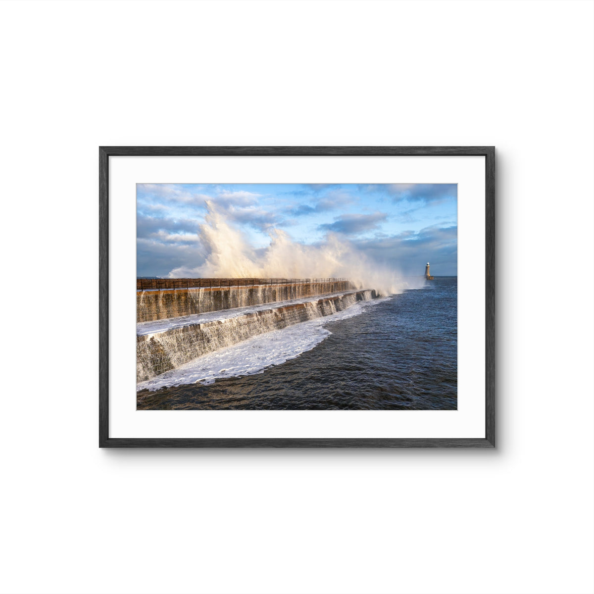 Framed photograph of a dam with water flowing over it on a white background
