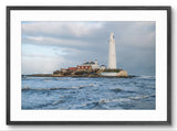 Lighthouse on a rocky island with waves in the foreground, framed picture.