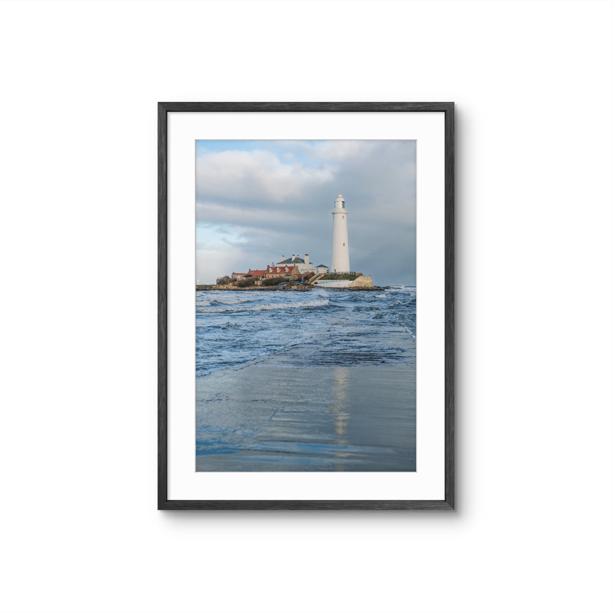 Framed artwork of a lighthouse on an island with water and sky in the background
