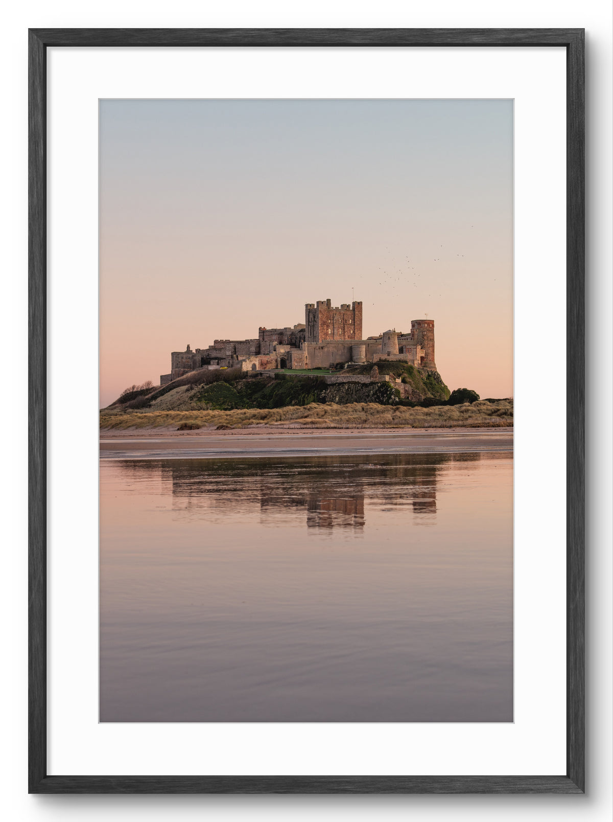 Castle reflected in water at sunset with a black frame