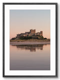 Castle reflected in water at sunset with a black frame