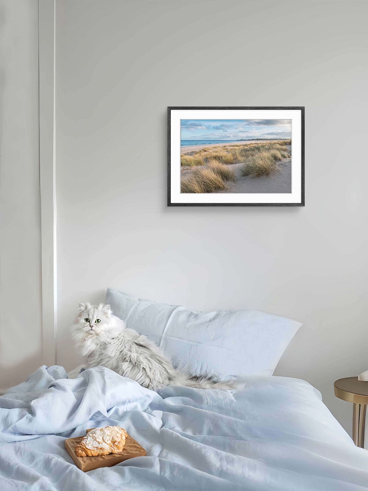 Romm with picture of Ross Sands beach in Northumberland with rolling sand dunes and calm coastal shoreline
