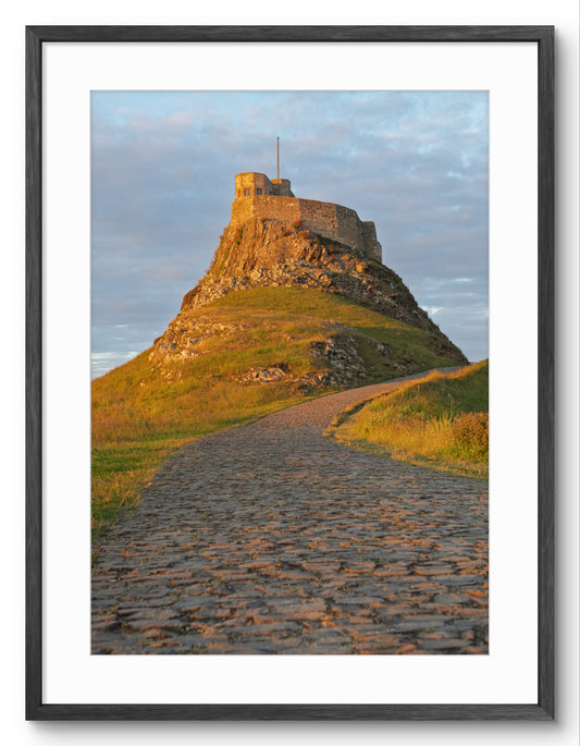 Castle on a hill with a path leading up to it, framed in black
