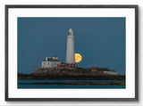 Lighthouse on an island with a full moon in the background, framed picture.