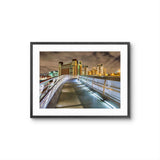 Framed photograph of a cityscape with a bridge at night.