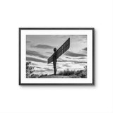 Framed black and white photograph of the Angel of the North sculpture against a cloudy sky.
