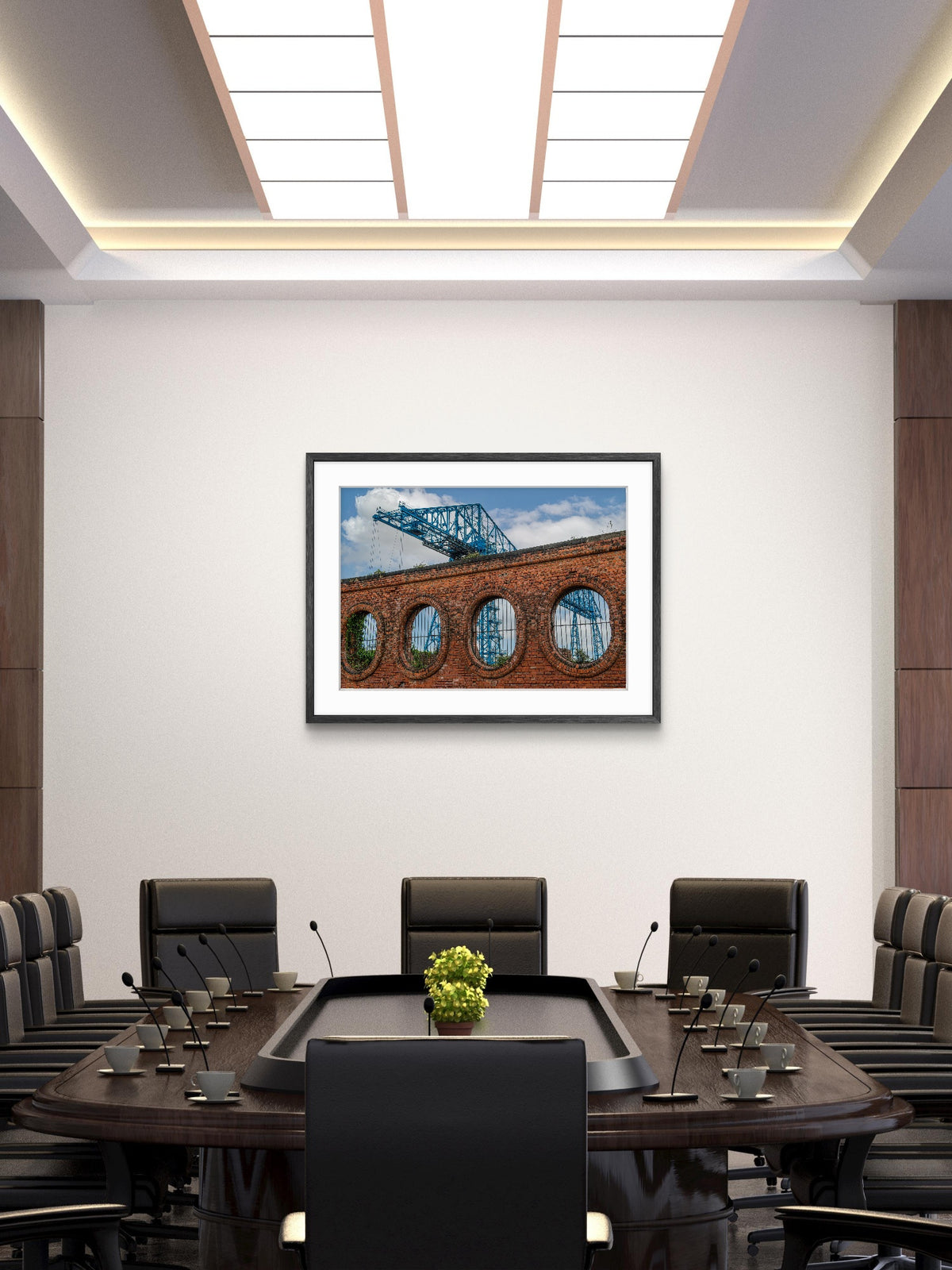 Modern conference room with a large table and chairs, framed picture on the wall.
