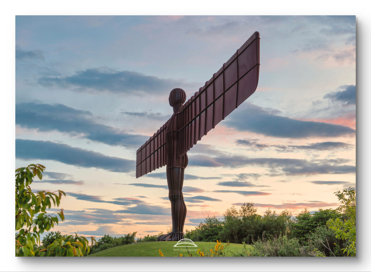 A square wall art print depicting the Angel of the North sculpture at sunset, shown with a subtle drop shadow on a white background.