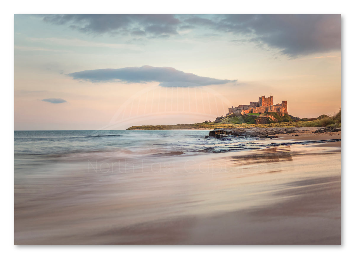 Bamburgh Castle reflected on the beach shown as a canvas print.