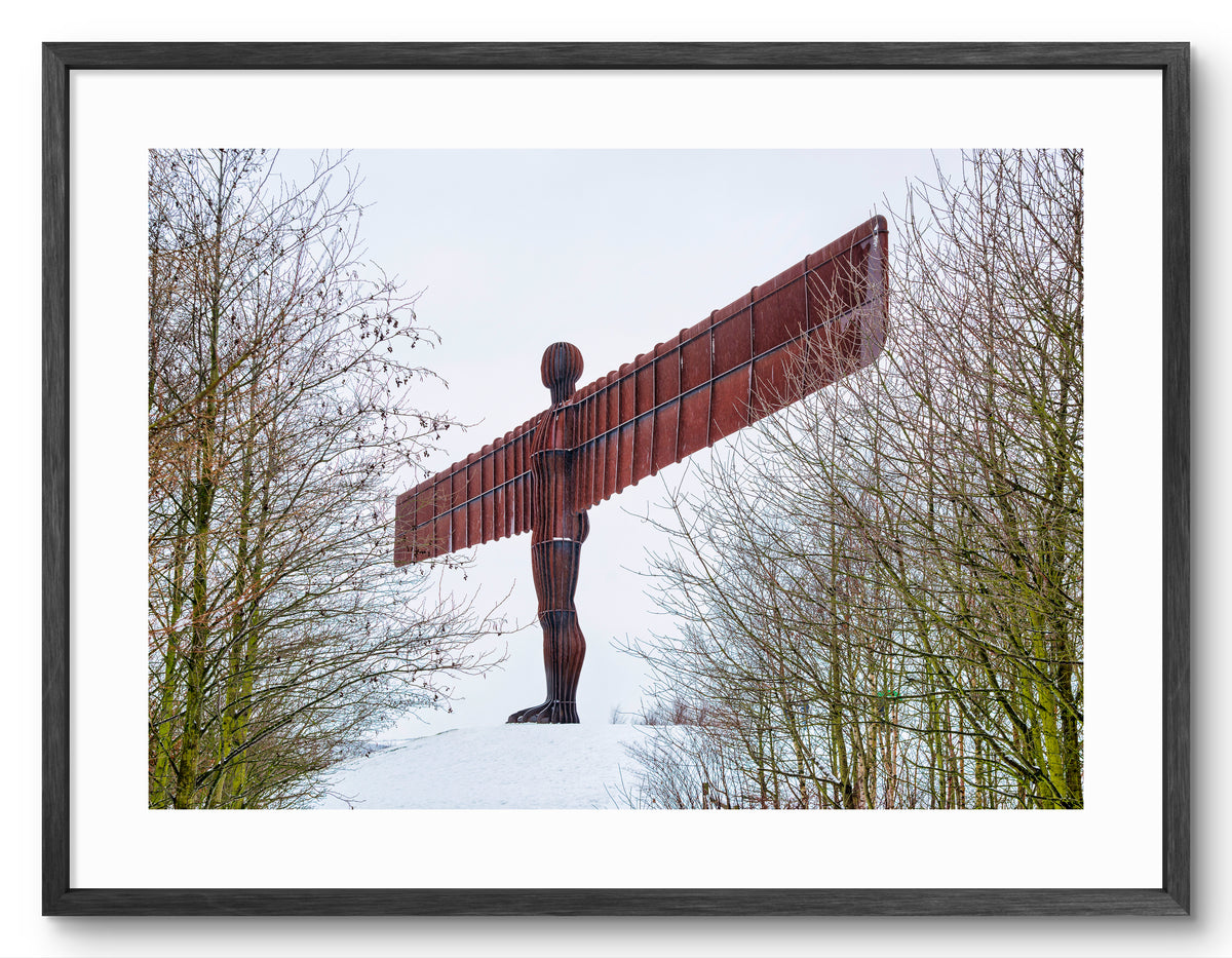 The Angel of the North - Snow - Gateshead shown as a framed photographic print.