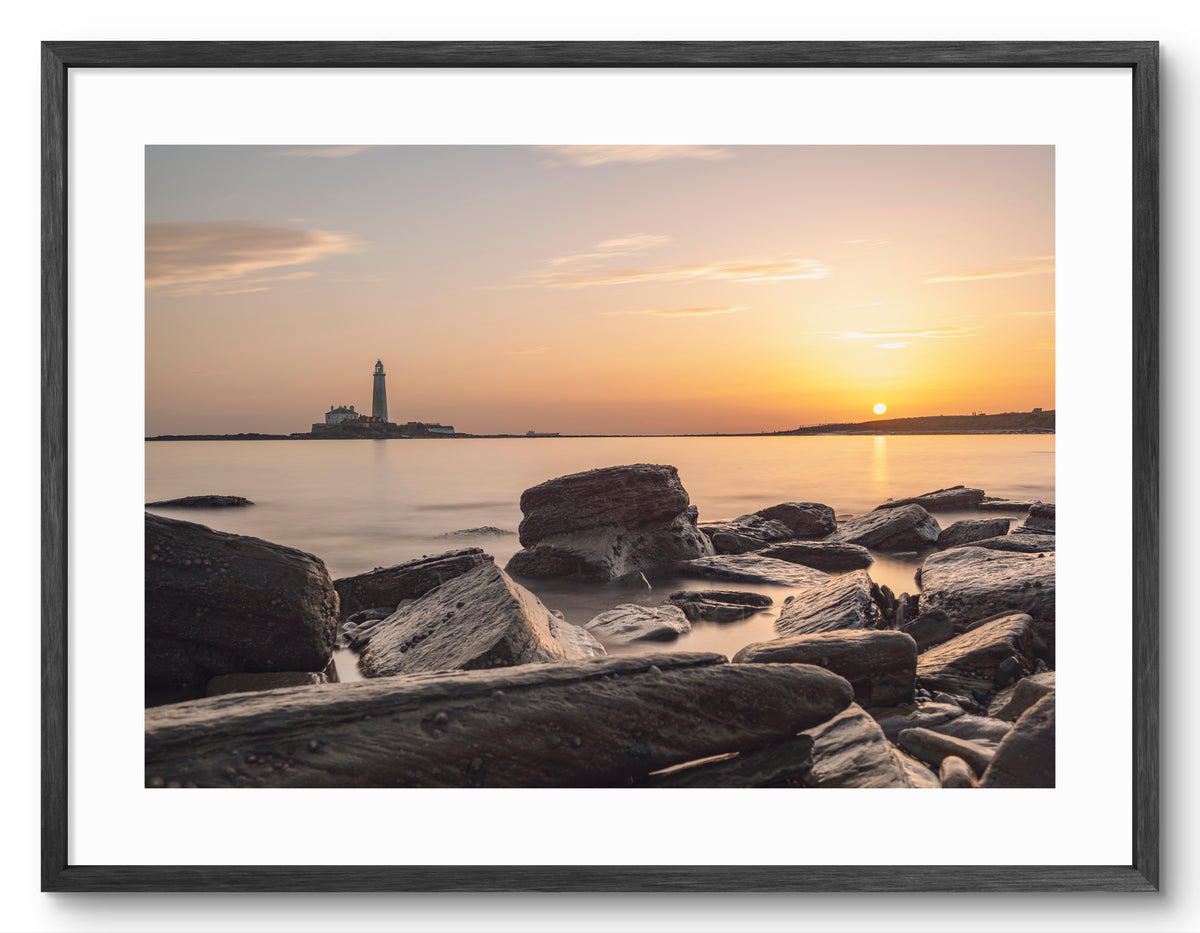 St Mary's Lighthouse and Rocks - Sunrise - Whitley Bay shown as a framed photographic print.