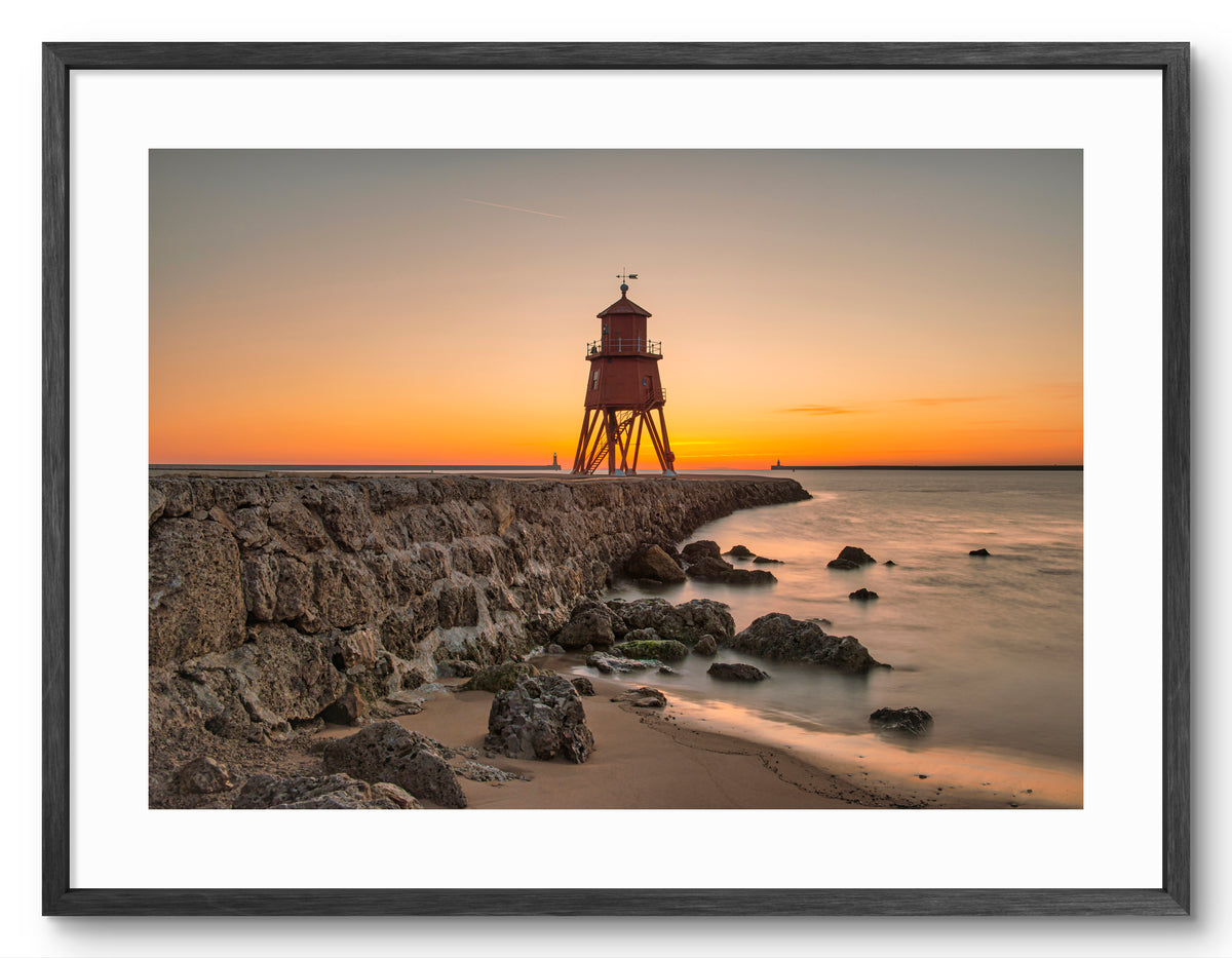 Herd Groyne Lighthouse - Golden Sunrise - South Shield shown as a framed photographic print.