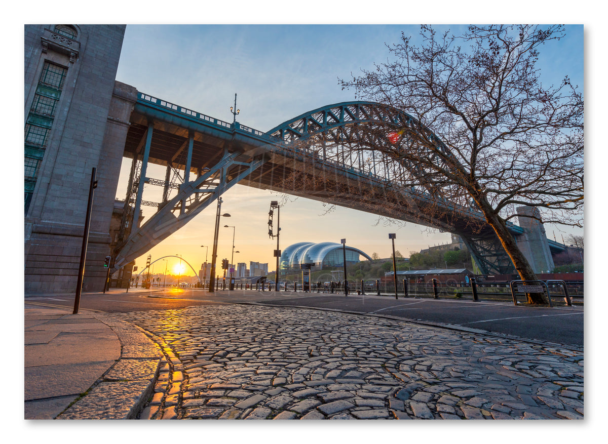Newcastle Quayside Sunrise with Tyne Bridge & Cobbles shown as a canvas print.
