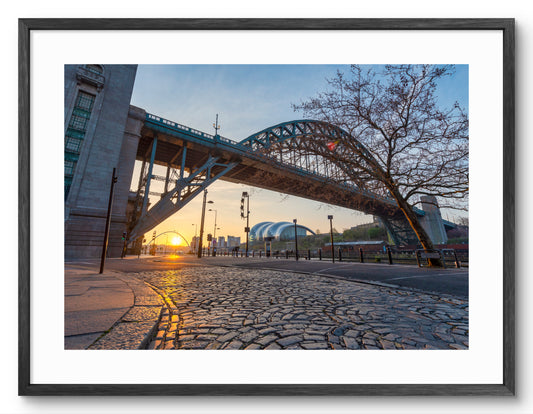 Newcastle Quayside Sunrise with Tyne Bridge & Cobbles shown as a framed photographic print.